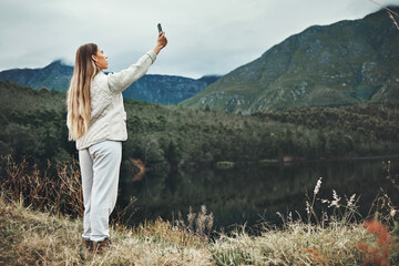 Canvas Print - Woman, selfie and forest, mountains or nature in search of network, connection or internet outdoor. Young person camping, travel or hiking with adventure photography or mobile for location by lake