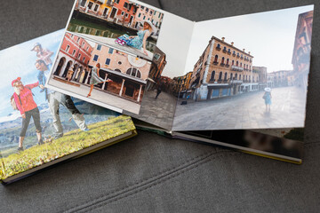 Open pages of album photobook couple in love on wooden background