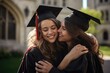 © Oulaphone - Young women embracing each other after graduation ceremony on university.
