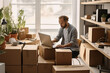 Online salesperson packing boxes for dispatch to customers, online seller working from home