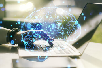 Wall Mural - creative artificial intelligence concept with human brain hologram and hands typing on laptop on bac