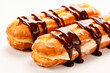 eclairs with cream and chocolate on a white background