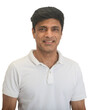 A smart middle-aged fit Indian man in a white t-shirt - studio shot