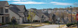 Panorama speed limit at 25 miles on residential street leading down steep hill, row of two-story houses, new development subdivision neighborhood upscale, Atlanta, Georgia, USA