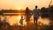 Un papa, une maman et leur fils se tenant la main de dos avec un coucher de soleil au bord de mer.