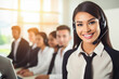 © tantawat - young woman working as a call center operator, wearing headphones with smile and good service