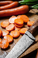 Sticker - Fresh chopped carrots on a cutting board.