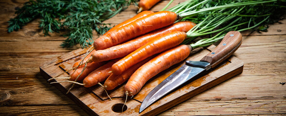 Sticker - Fresh carrots on wooden table.