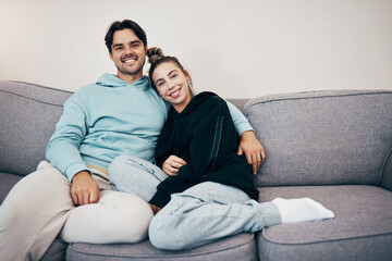 Poster - Portrait, relax and smile with a couple on a sofa in the living room of their home together for bonding. Love, hug or date with a happy man and woman in their apartment for romance or relationship