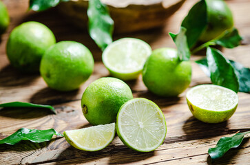 Wall Mural - Fresh limes. On wooden table.