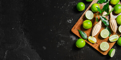 Wall Mural - Fresh limes. On black table.