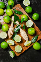 Poster - Fresh limes. On black table.