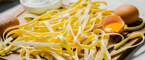 Sticker - Homemade pasta tagliatelle. On white table.