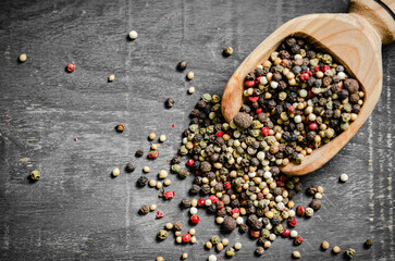 Peppercorn on rustic background.