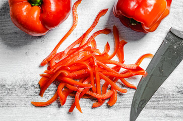 Wall Mural - Chopped sweet pepper. On white table.