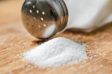 Salt background . On wooden table.