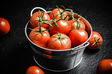 Canvas Print - Fresh tomatoes. On black table.