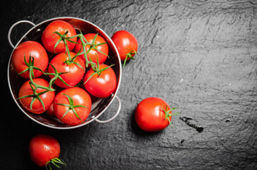 Canvas Print - Fresh tomatoes. On black table.