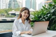 © AI Farm - Portait of Asian business woman smile with computer laptop. Generative AI