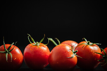 Poster - Fresh tomatoes. On black table.