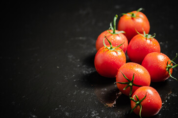 Poster - Fresh tomatoes. On black table.