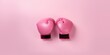 Pink boxing gloves, symbolizing womens sport, concept of Feminine empowerment