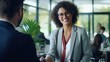 © Malynka - Happy Smiling mature Latin business woman manager or lawyer handshaking client at office meeting. Smiling professional businesswoman and businessman shake having partnership agreement with handshake