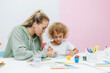 © inna717 - mother and child draw. daughter is engaged in creativity. mother and daughter paint.