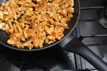 Wall Mural - Making turkish doner kebab at home. Dirty kitchen stove. Marinated chicken in spices. Gyros dish recipe. Dinner frying background. Simple meat background. Closeup food texture.