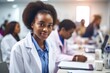 © Rawf8 - Doctor at work, Afro American woman in medical coat, blur background