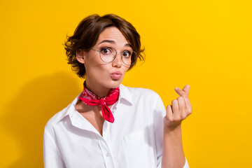 Wall Mural - Photo of cute lovely lady pouted lips kiss arm fingers demonstrate korean love symbol isolated on yellow color background