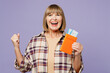 © ViDi Studio - Traveler elderly woman wear beige casual clothes hold passport ticket isolated on plain pastel purple background. Tourist travel abroad in free spare time rest getaway Air flight trip journey concept
