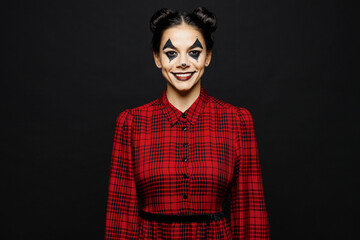Wall Mural - Young smiling cool woman with Halloween makeup face art mask wearing clown costume red dress looking camera isolated on plain solid black wall background studio portrait. Scary holiday party concept.