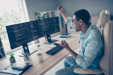 side shot of crazy young guy celebrating his code works without bugs he raised fists up hooray softw