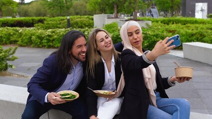 Wall Mural - Multiracial business people eating together healthy poke food during lunch break outside of office while taking a selfie using mobile phone 