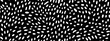 Seamless small dense polkadot animal spots pattern in white on black background. Abstract aboriginal dot art motif or organic cellular texture in a trendy doodle line art or linocut style