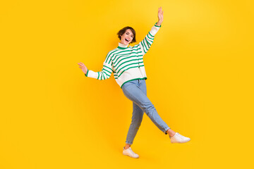 Sticker - Full body photo of attractive careless girl wear casual stylish striped pullover with jeans party event isolated on yellow color background