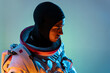 © ADDICTIVE STOCK - Astronaut in spacesuit and head cover hood looking away on blur background
