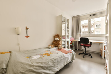 Wall Mural - a child's room with a bed, desk and window in the corner to the right is an office