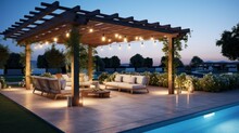 Teak Wooden Deck With Decor Furniture And Ambient Lighting. Side View Of Garden Pergola With Gas Grill At Twilight