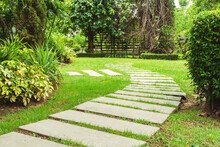 Garden Landscape Design With Pathway Intersecting Bright Green Lawns And Shrubs White Sheet Walkway In The Garden.