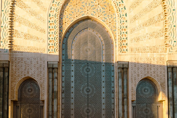 Wall Mural - Moroccan mosaic and patterns , view of Hassan II Mosque big gate, Detail of Hassan II Mosque at sunset in Casablanca, Morocco