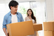 © chachamp - Happy Asia couple holding cardboard box with walk in new home
