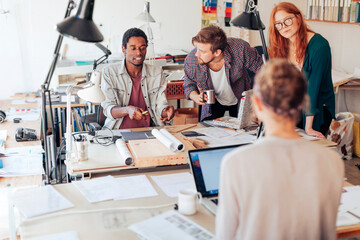 Wall Mural - Young and diverse group of architects working on a project together in a startup company office