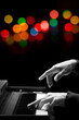 © princeoflove - closeup male pianist hands playing piano with colorful bokeh. music background