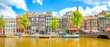 Panorama of Amsterdam city, scenic skyline over Amstel canal, Netherlands