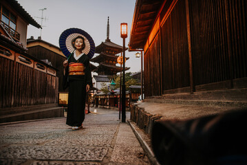 Wall Mural - Beautiful japanese senior woman walking in the village. Typical japanese traditional lifestyle