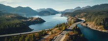 Aerial Perspective Of A Winding Section Of The Sea To Sky Highway, Showcasing The Road's Integration With The Stunning Coastal Landscape.