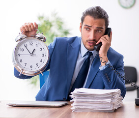 Wall Mural - Young male businessman working in the office