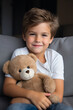 © ADDICTIVE STOCK - Generative AI illustration of happy kid looking at camera and embracing huge teddy bear while sitting on sofa at home against blurred background